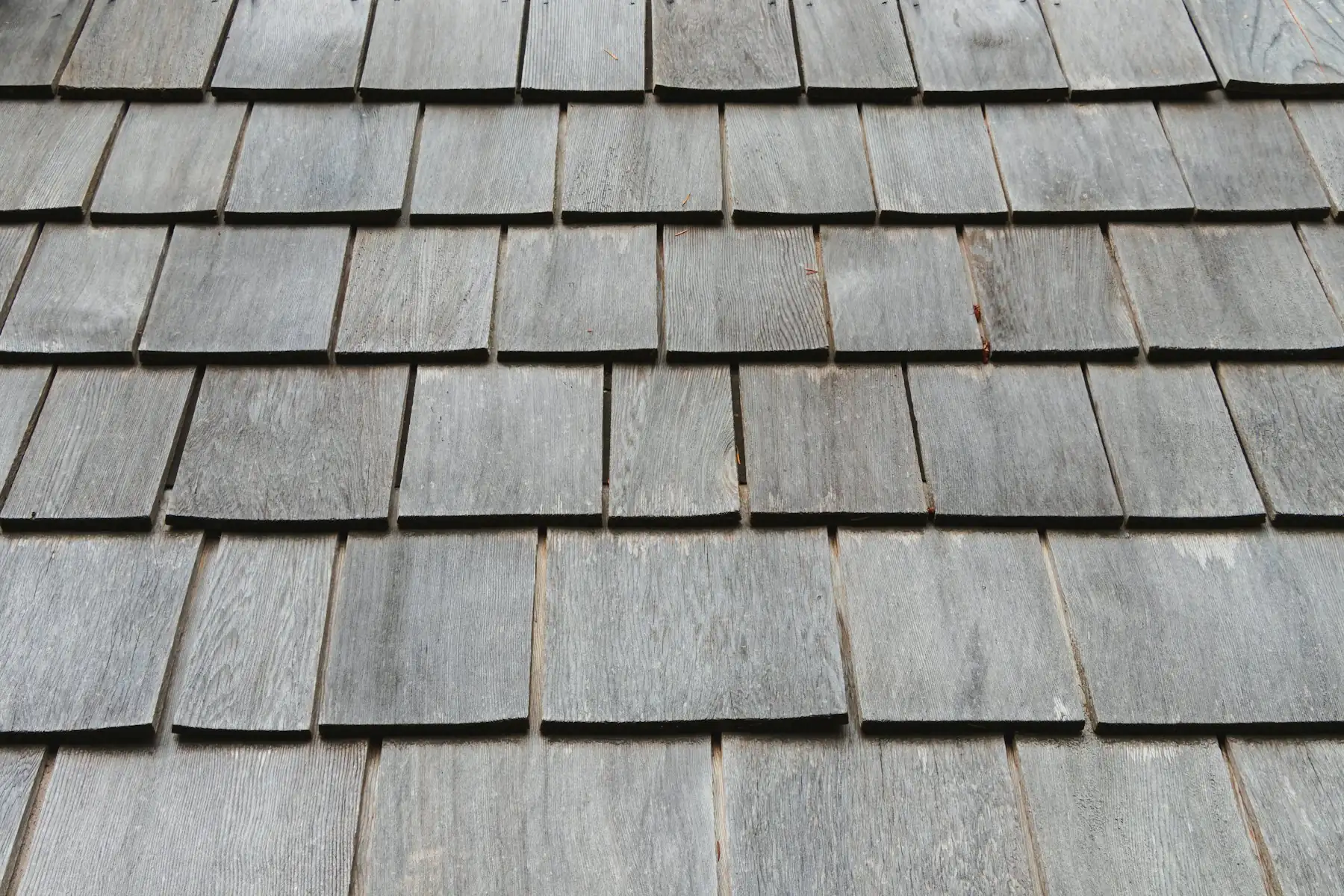 Close-up of gray overlapping roof shingles